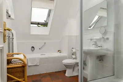 a white bathroom with a toilet and a sink at Gable Manor by Neighbourgood in Franschhoek