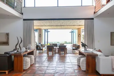 a large living room with a table and chairs at Manor at Longridge in Helderberg