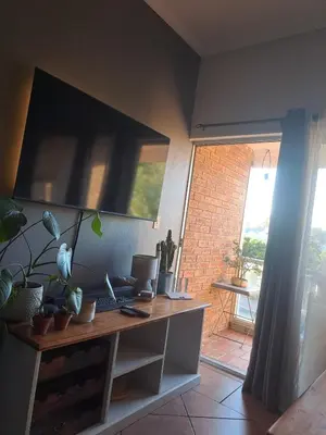 a room with a desk with a computer on it at Central 3rd Floor Durbanville Apartment in Durbanville