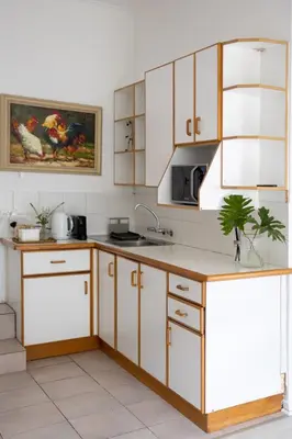 a kitchen with white cabinets and a sink at Private Garden Flat in Die Boord with Secure Parking in Stellenbosch