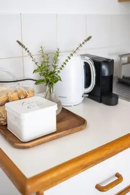 a kitchen counter with a coffee pot and a tray of pastries at Private Garden Flat in Die Boord with Secure Parking in Stellenbosch