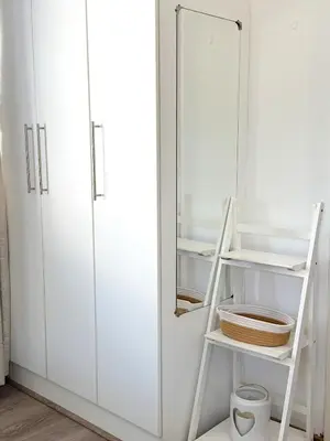 a closet with a white cabinet and a shelf at Olly-Pops Cottage in Tygerberg Hills