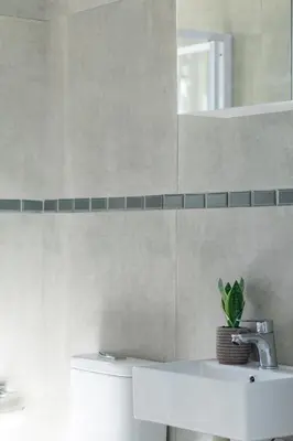 a bathroom with a toilet and a sink and a mirror at Flatlet on Circle in Cape Town