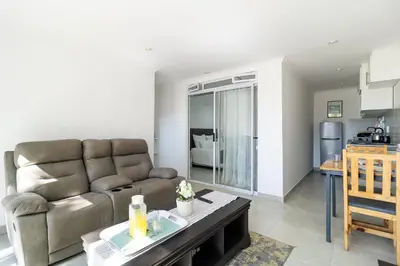 a living room with a couch and a table at Flatlet on Circle in Cape Town