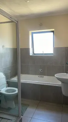 a bathroom with a tub and a toilet and a sink at Delightful Retreat in Parklands,Cape Farms,Cape Town in Cape Town