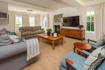 a living room with a couch and a table at Fir Close 3 bedroom in Hermanus