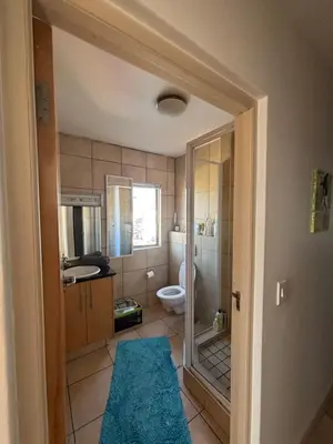 a bathroom with a toilet and a sink and a shower at Koras little heaven in Strand