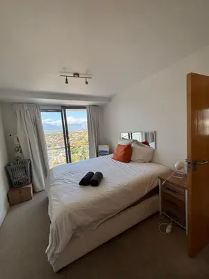a bedroom with a large bed with a large window at Koras little heaven in Strand