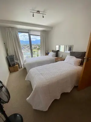 a bedroom with two beds and a large window at Koras little heaven in Strand