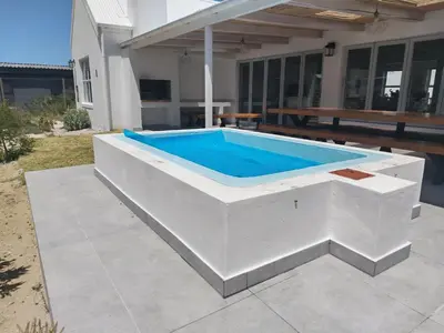 a swimming pool in the middle of a house at Taylah's Hideaway in Bettyʼs Bay