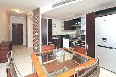 a kitchen with a glass table and chairs at City Vibes and Mountain Highs 2 Bed, 2 Bath Apart