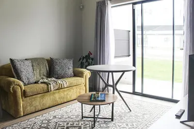 a living room with a couch and a table at Flat in Security Estate - Zomerwind Apartments in Oakdale