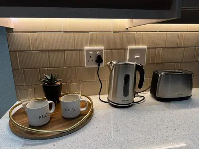 a counter with three coffee mugs on a tray at Montblanc 3 Bed 3 Bath House in residential security Estate in Stellenbosch
