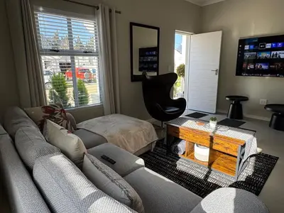 a living room with a couch and a table at Montblanc 3 Bed 3 Bath House in residential security Estate in Stellenbosch