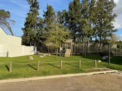 a park with a wooden fence and a playground at Montblanc 3 Bed 3 Bath House in residential security Estate in Stellenbosch
