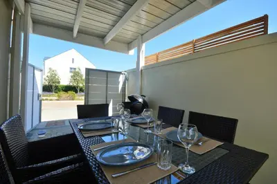 a dining table with wine glasses on top of it at Montbleu 3 Bed 3 Bath House in residential security Estate in Stellenbosch