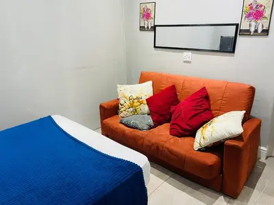 a couch with pillows on it in a room at Annika`s dormitory in claremont in Cape Town