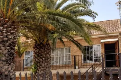 two palm trees in front of a building at The Palm in Kraaifontein