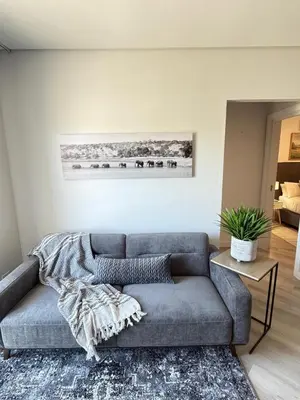 a living room with a couch and a table at Platform 123 - 2 On Tabak with onsite Parking in Paarl
