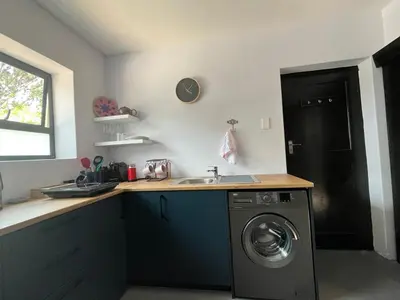 a kitchen with a sink and a washing machine at Pelikaan 5 in Stellenbosch