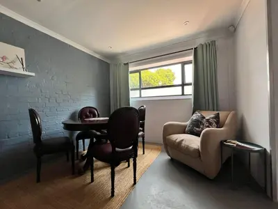 a living room with a table and a couch at Pelikaan 5 in Stellenbosch