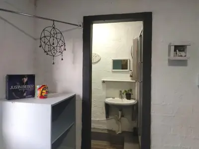 a white bathroom with a sink and a mirror at Cocos Island in Bettyʼs Bay