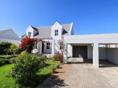 a large white house with a driveway at Salt & Butter in Hermanus