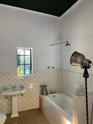 a bathroom with a bath tub and a sink at The Barn, at Glenora Avenue in Somerset West