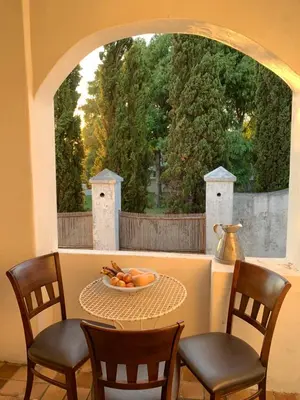 a table with chairs and a bowl of fruit on it at The Barn, at Glenora Avenue in Somerset West