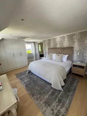 a bedroom with a large bed with a rug at 9 Charme in Stellenbosch