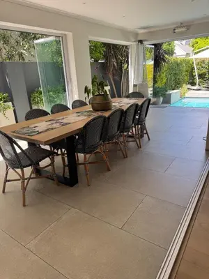 a dining room with a wooden table and chairs at 9 Charme in Stellenbosch