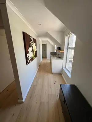 an empty room with a kitchen and a living room at 9 Charme in Stellenbosch