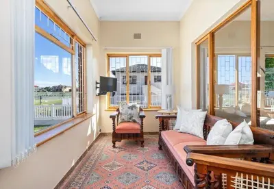 a living room with a couch and large windows at Sea view holiday home in Kleinmond