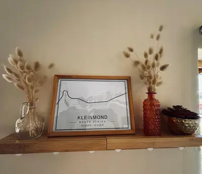 a shelf with three vases and a picture on it at Sea view holiday home in Kleinmond