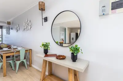 a mirror on a wall in a room with a table at Blu Horizon in Cape Town