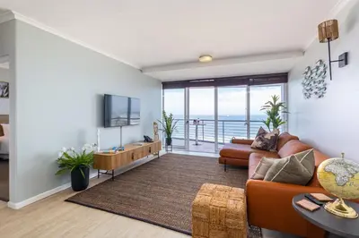 a living room with a couch and a television at Blu Horizon in Cape Town