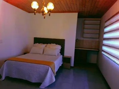 a bedroom with a bed in a room with a window at ABSD home in Avondale