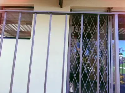 a window with iron bars on a house at ABSD home in Avondale