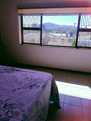 a bedroom with a bed and a window with a view at ABSD home in Avondale
