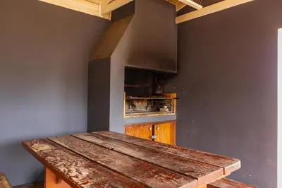 a kitchen with a wooden table in a room at Bona Vista in Pringle Bay