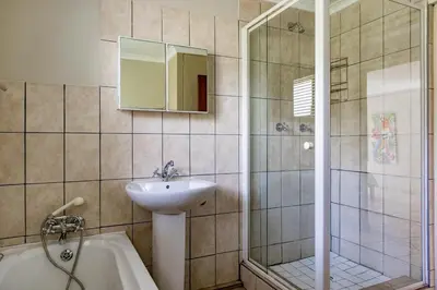 a bathroom with a sink and a shower and a tub at Bona Vista in Pringle Bay
