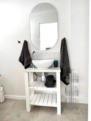 a bathroom with a white sink and a mirror at Mountain View Voëlklip One Bedroom in Hermanus