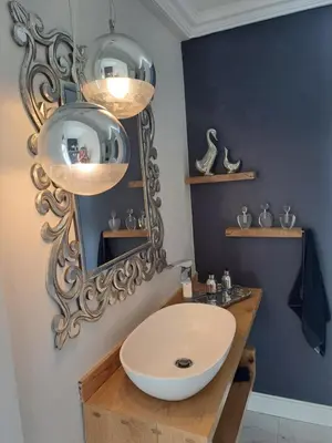 a bathroom with a white sink and a mirror at Boutique Inn - Azure in Gordonʼs Bay