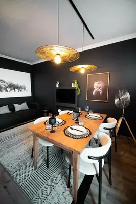 a dining room with a wooden table and chairs at The Onyx Stellenbosch in Stellenbosch