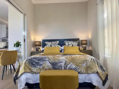 a bedroom with a large bed with yellow pillows at The Hidden Gem in Oakdale