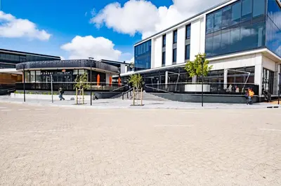 a large building with trees in front of it at 622 Riverlands - Lux 2 Bedroom Apartment in Cape Town
