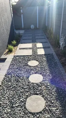a walkway with rocks and a building at Frankie's Nest in Cape Town