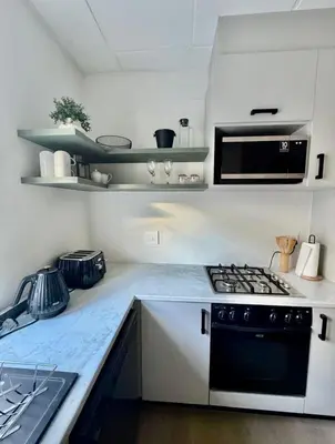a kitchen with a stove and a counter top at Finch Nest Self Catering in Paarl