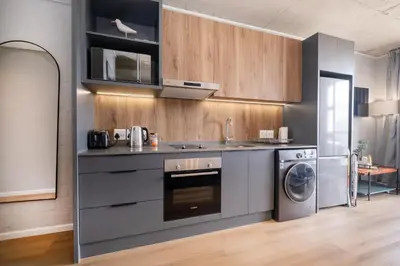 a kitchen with a sink and a dishwasher at 805 Riverlands - Lux Studio Apartment in Cape Town