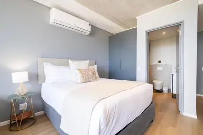 a bedroom with a large white bed in a room at 805 Riverlands - Lux Studio Apartment in Cape Town